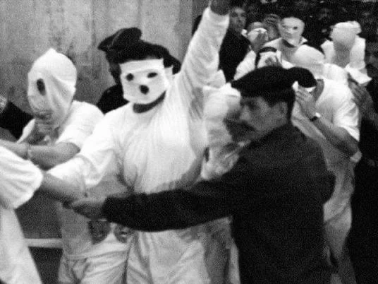 Archival photograph of the May 2001 Queen Boat arrests — detainees with white hoods over their faces